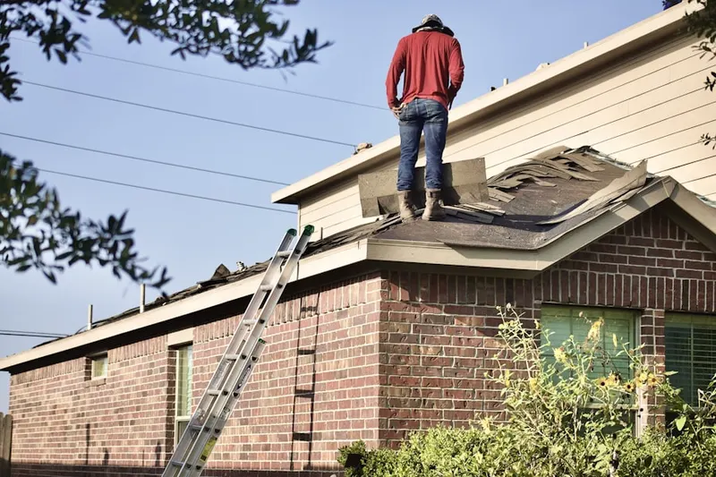 Professional roofer working on a residential roof in Vine Grove